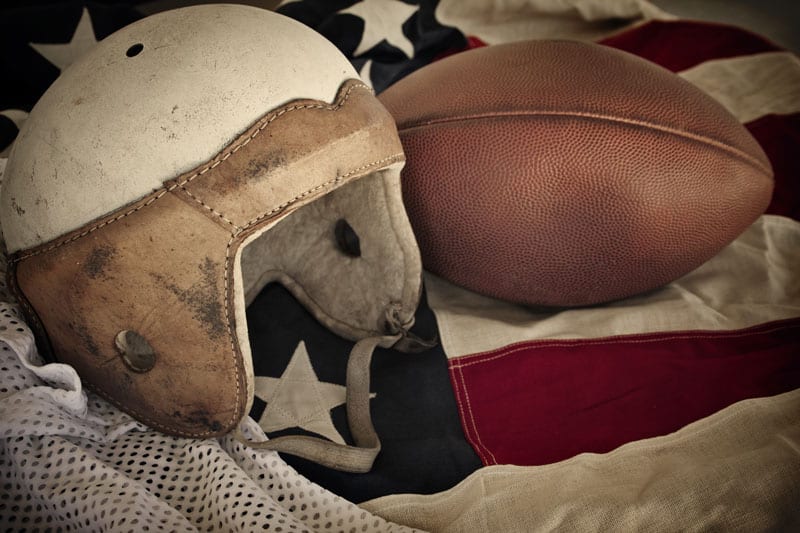 george barclay helmet next to football on USA flag